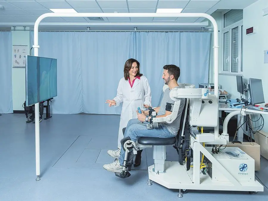 La neurologa Irene Aprile sorveglia la terapia: il dispositivo avvolge le braccia del paziente, guidandolo in movimenti che riproducono sullo schermo di fronte situazioni della vita quotidiana, grazie a un sistema di realtà virtuale (foto di Luigi Narici).